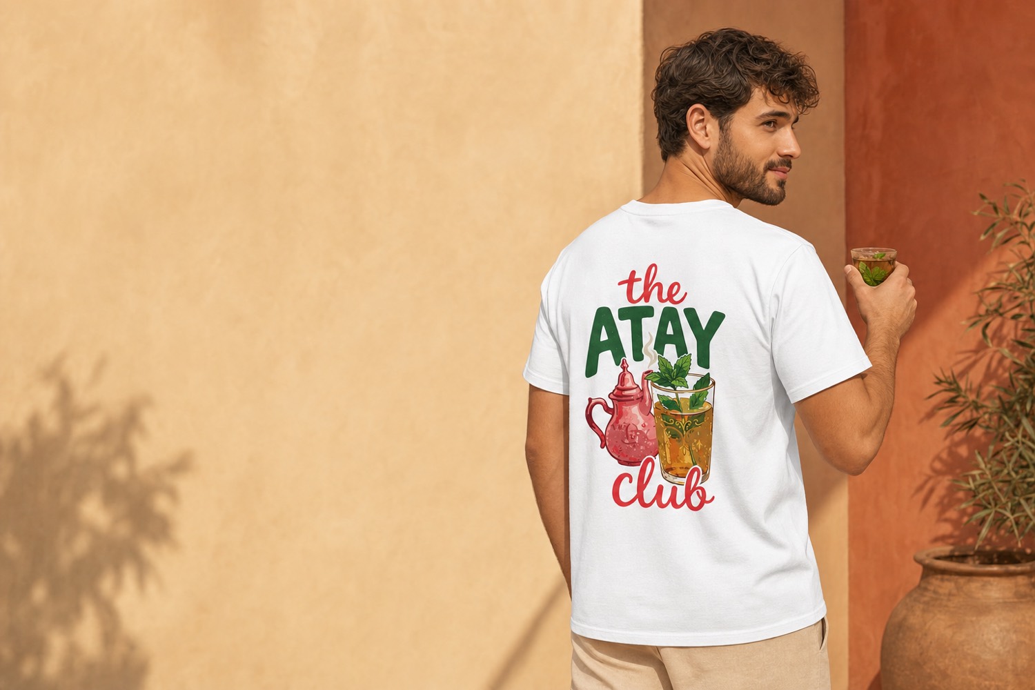 Model wearing The Atay Club t-shirt, showing the Moroccan teapot back print